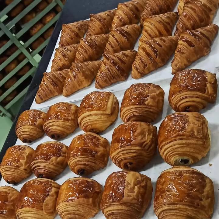 Tray of freshly baked croissants and pains au chocolat at Crookies Bakery Leicester