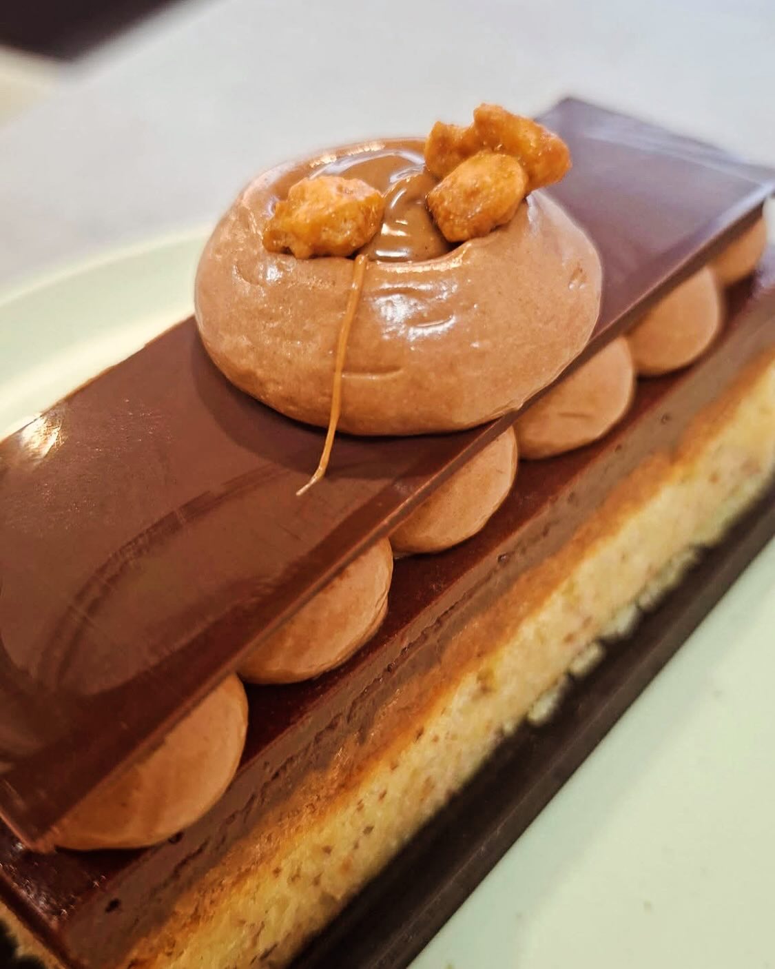 Chocolate praline artisan cake slice with mousse dome at Crookies Bakery Leicester
